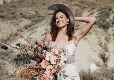 Wild wedding bouquet with dusky pink and earthy tones at stylish Queenstown wedding and bride wearing L'eto Bridal Gown