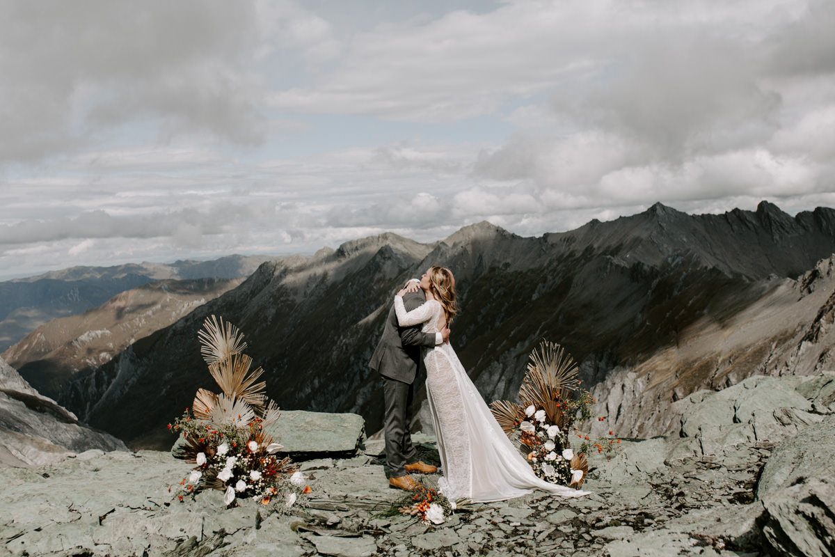 Bride and Groom with wild floral installation by The Lovers Elopement Co